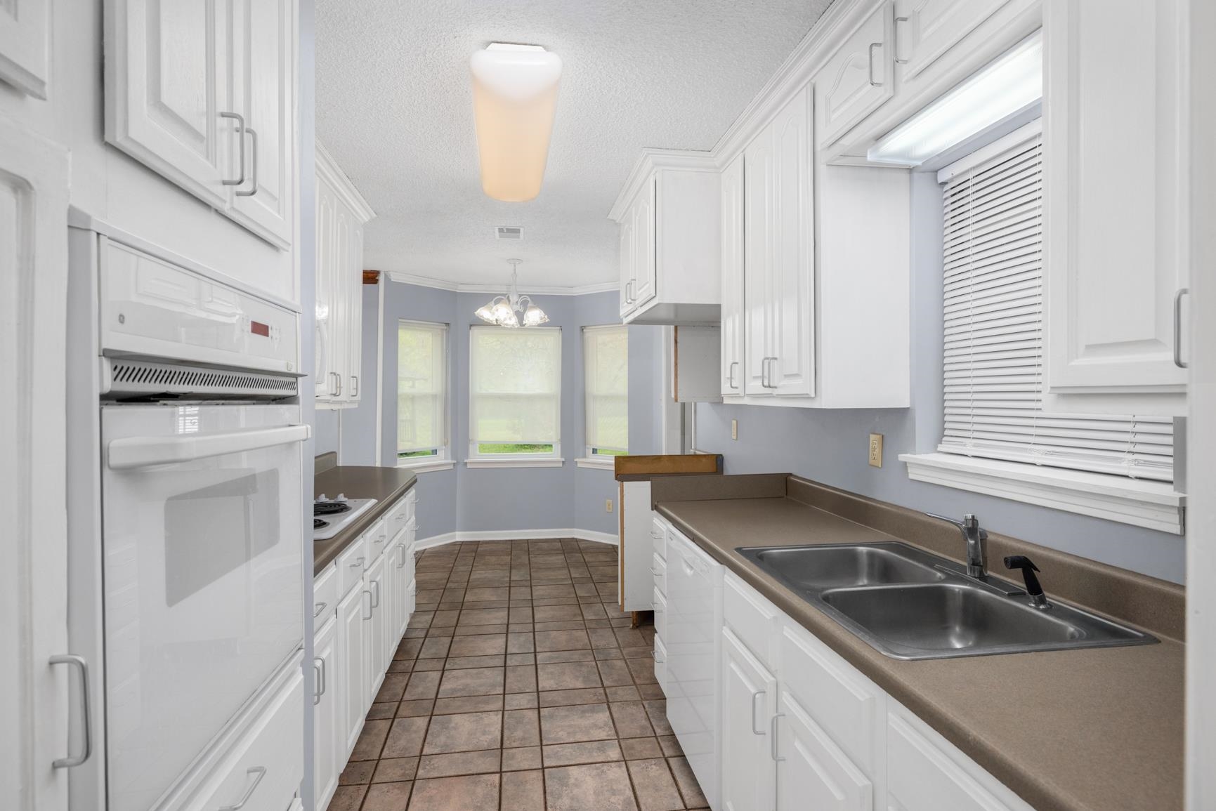 8292 Rankin Branch Road Millington, TN 38053 - Photo 9 of 33 a kitchen that has a sink cabinets counter space and stainless steel appliances