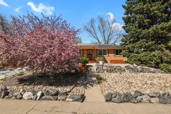 a front view of a house with a tree