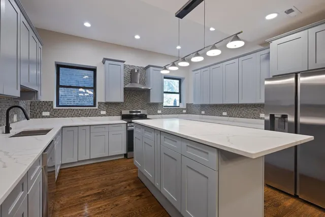 a kitchen with granite countertop a stove sink and cabinets