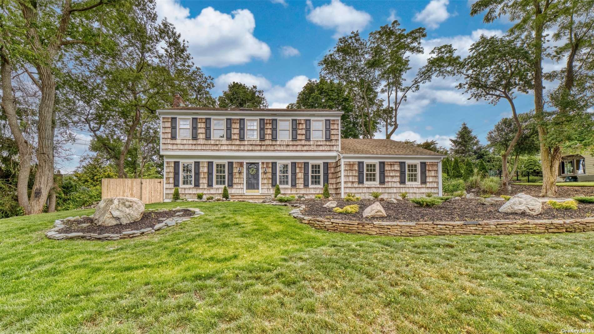 10 Carlisle Road Miller Place, NY 11764 - Photo 1 of 1 a front view of a house with a yard table and chairs