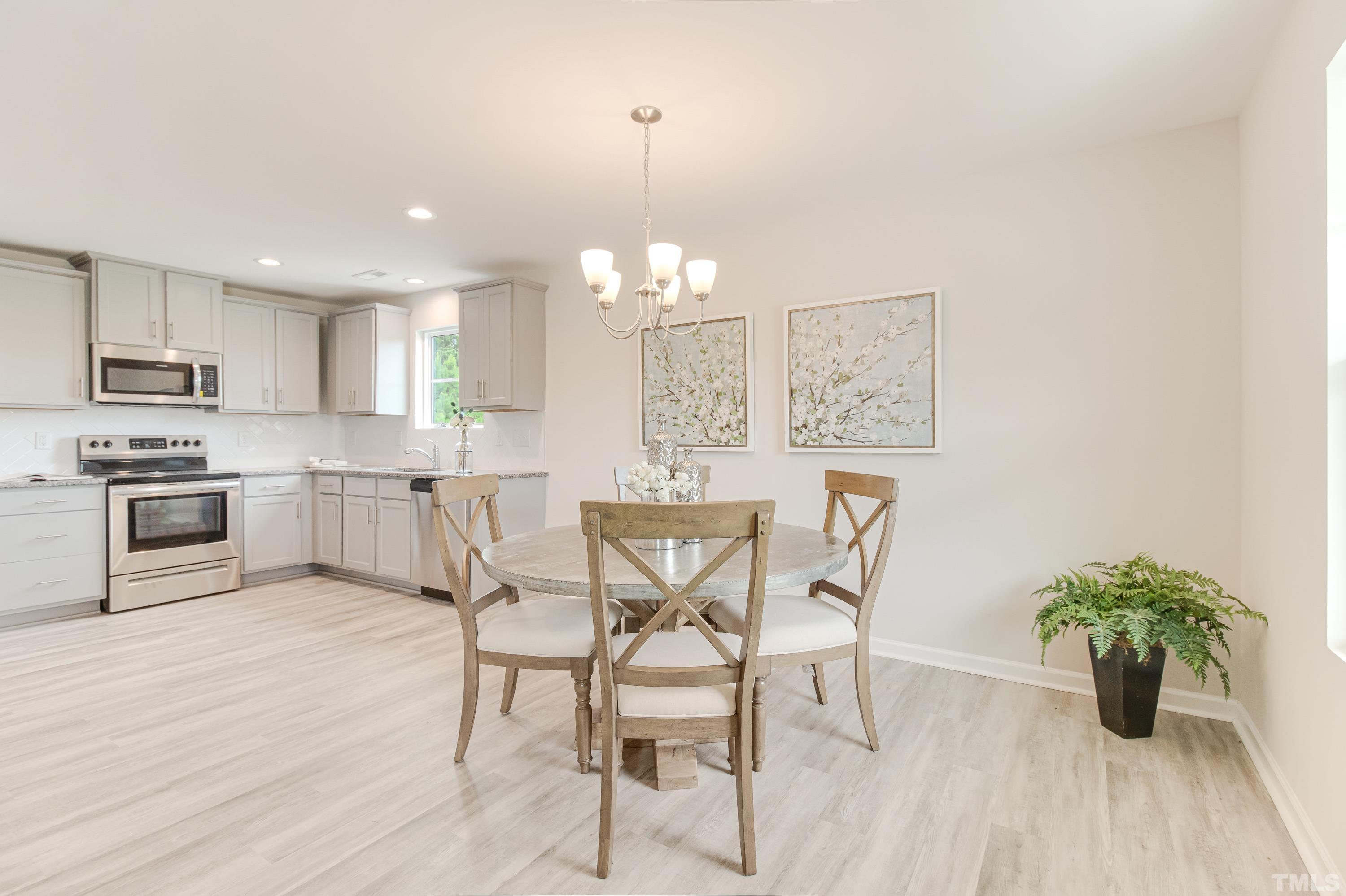 385 Dasu Drive Clayton, NC 27520 - Photo 13 of 33 a view of a dining room with furniture and wooden floor