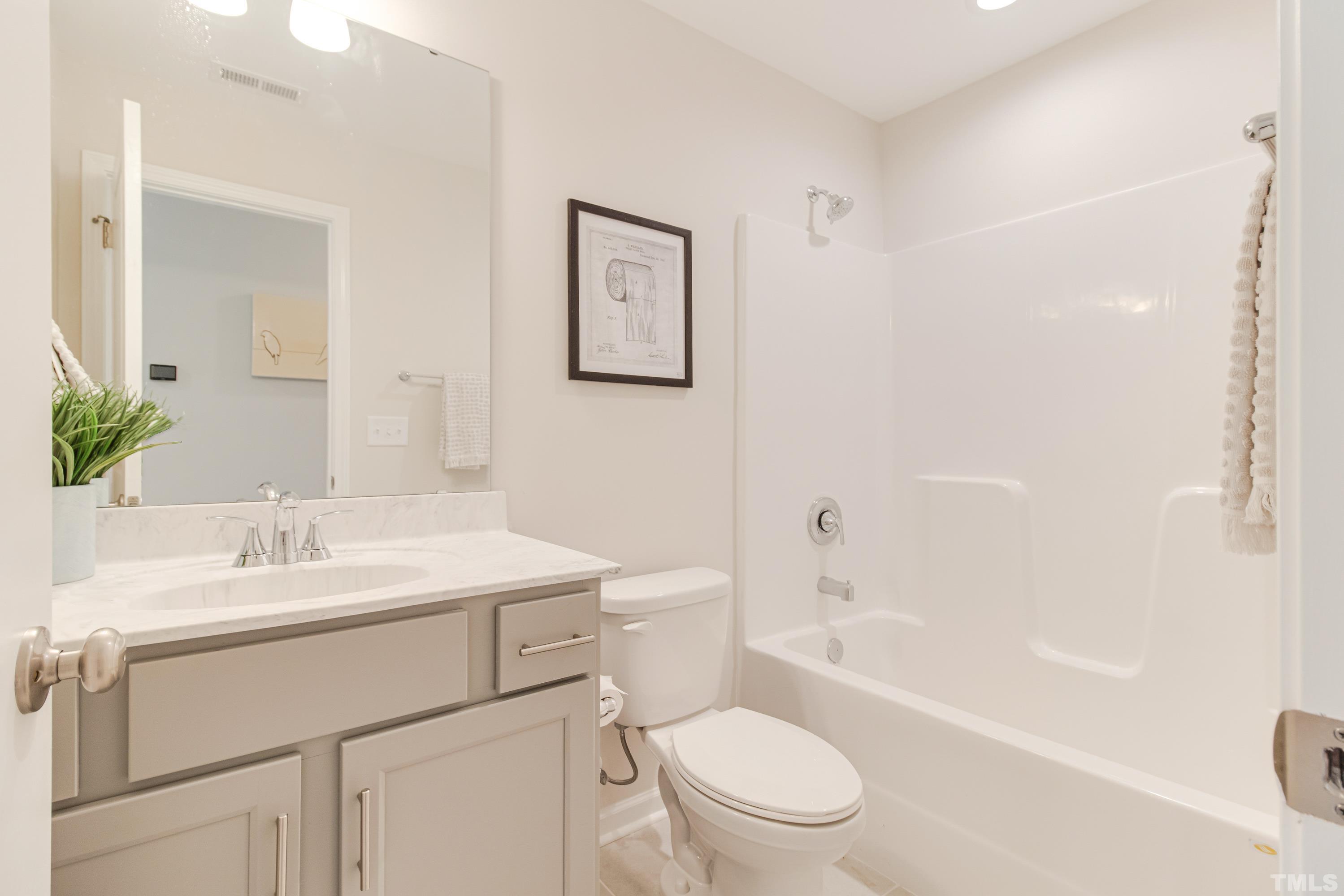 385 Dasu Drive Clayton, NC 27520 - Photo 20 of 33 a bathroom with a sink a toilet and shower