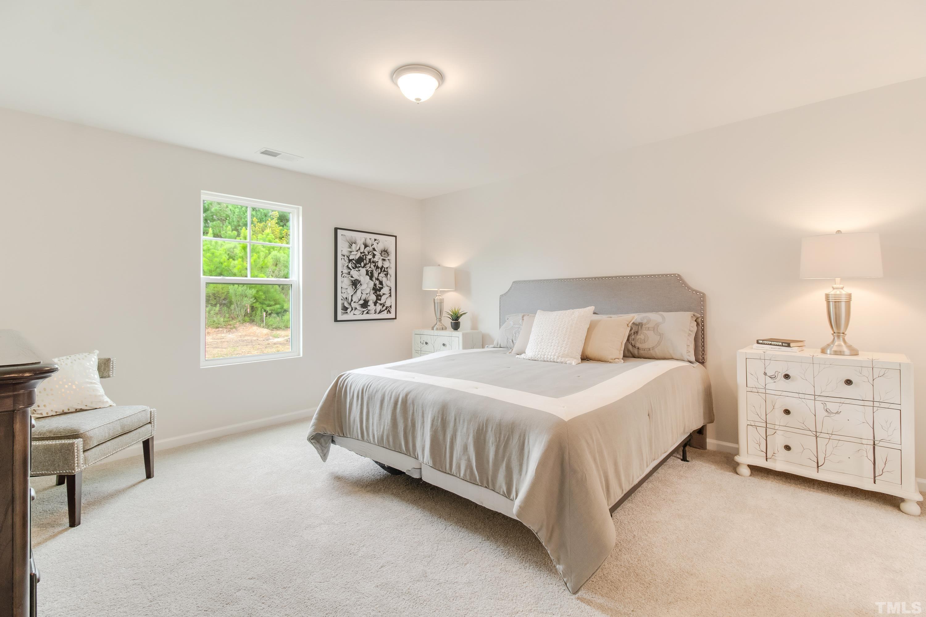 385 Dasu Drive Clayton, NC 27520 - Photo 23 of 33 a bedroom with a bed and a window