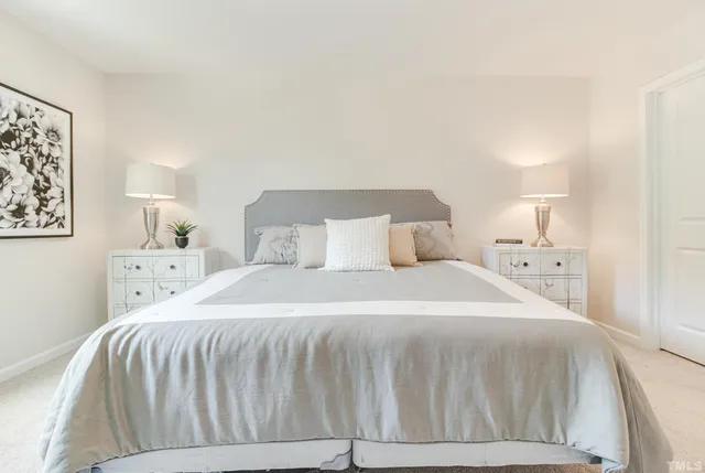 a bedroom with a bed and a night stand