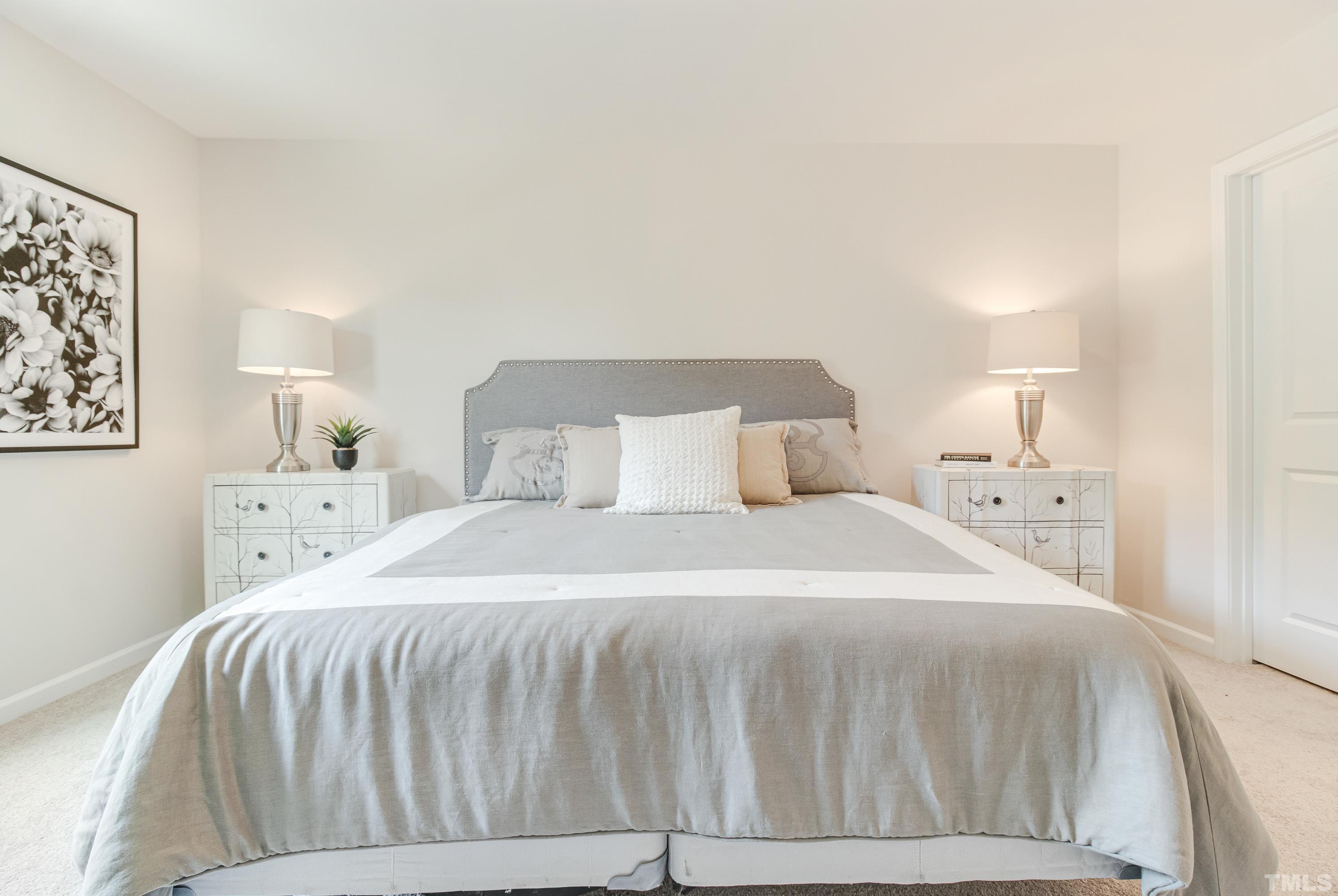 385 Dasu Drive Clayton, NC 27520 - Photo 24 of 33 a bedroom with a bed and a night stand