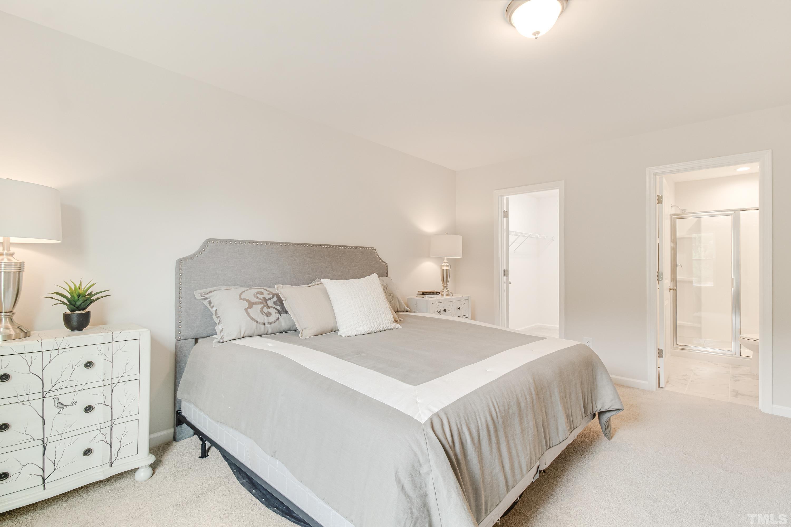 385 Dasu Drive Clayton, NC 27520 - Photo 25 of 33 a bedroom with a large bed and a closet