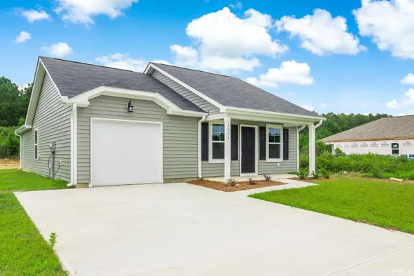 a front view of a house with a yard and garage