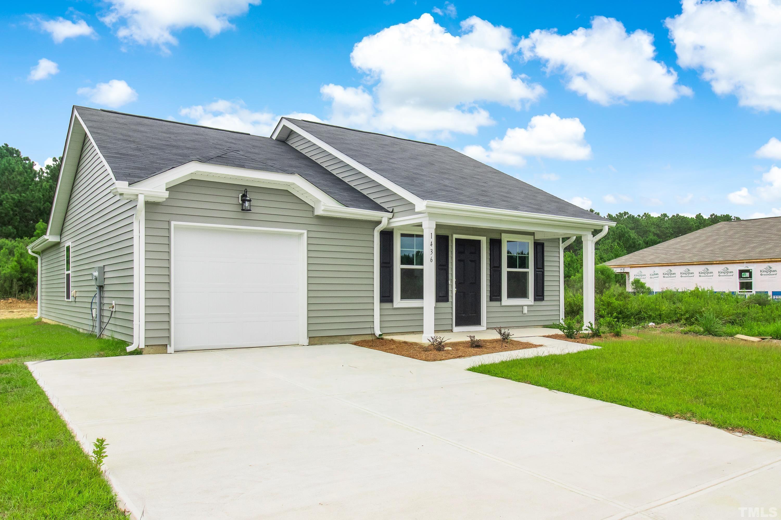 385 Dasu Drive Clayton, NC 27520 - Photo 4 of 33 a front view of a house with a yard and garage
