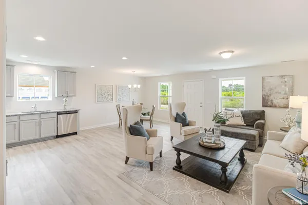 a living room with furniture and wooden floor