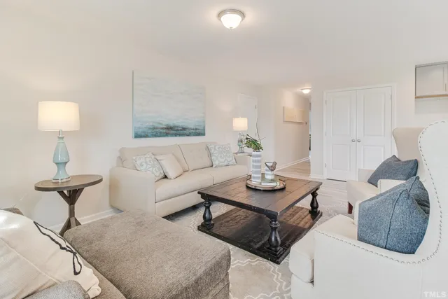 a living room with furniture and a lamp