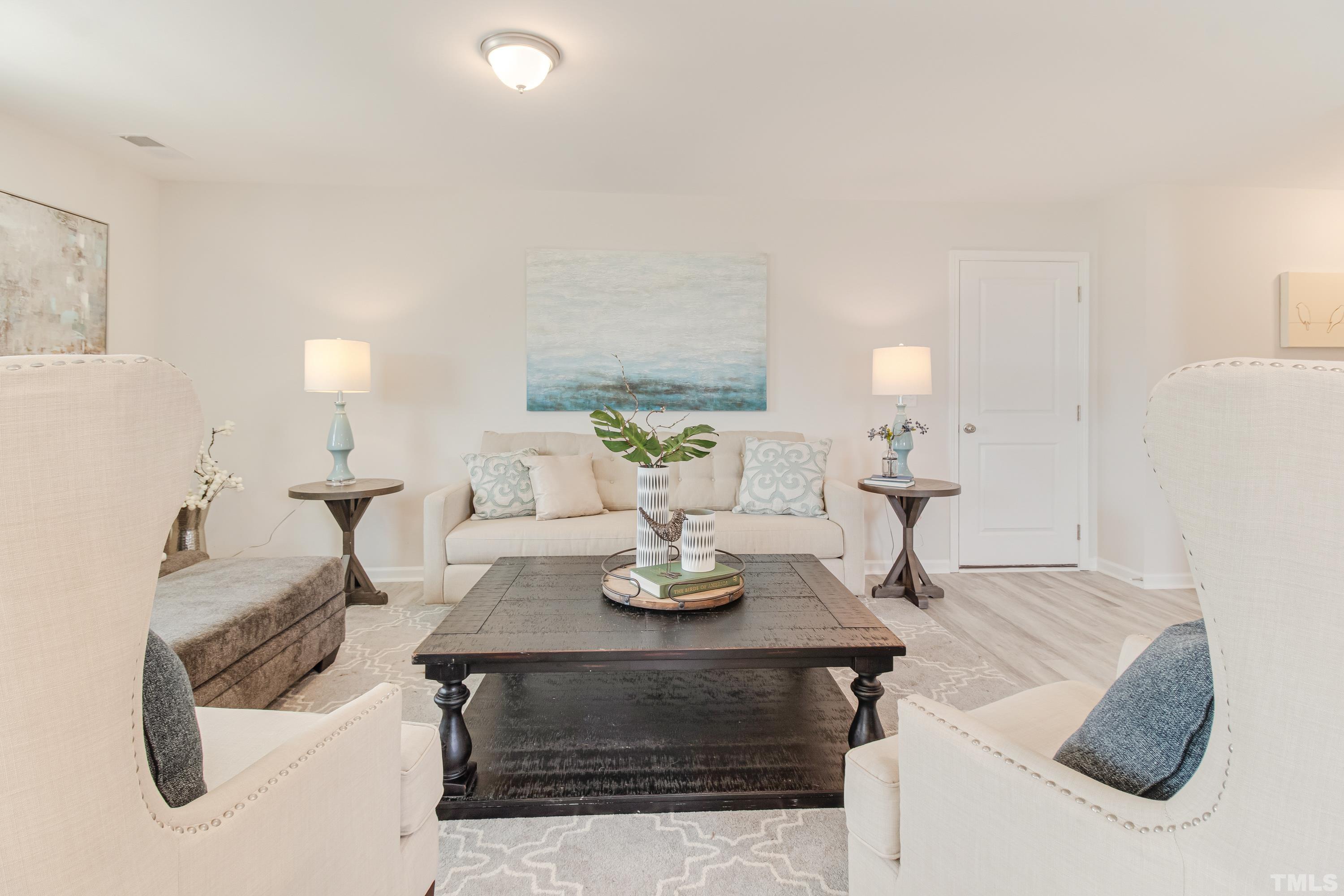 385 Dasu Drive Clayton, NC 27520 - Photo 10 of 33 a living room with furniture and a table