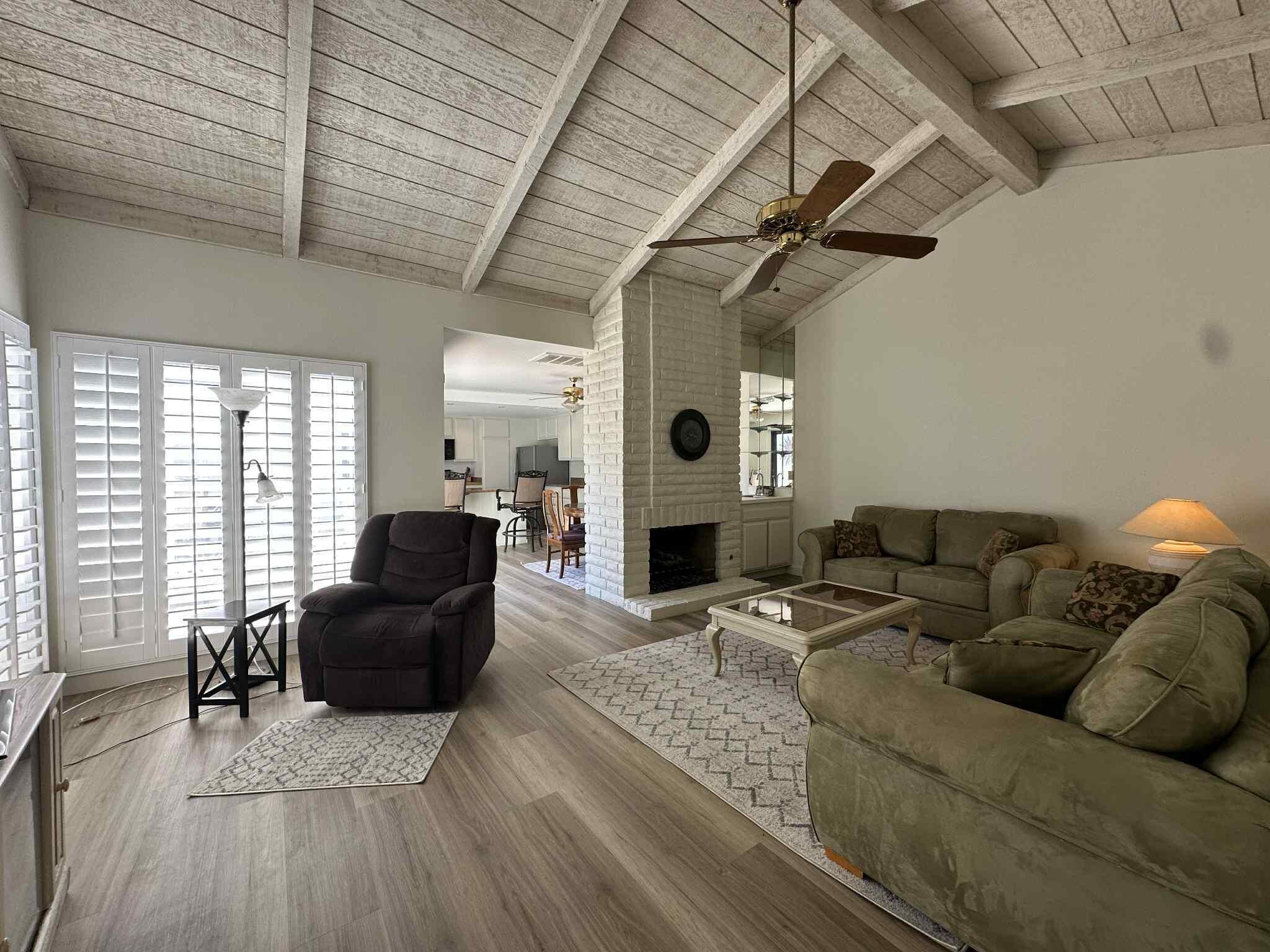 2350 East Miramonte Circle, Unit E Palm Springs, CA 92264 - Photo 12 of 35 a living room with furniture and a wooden floor