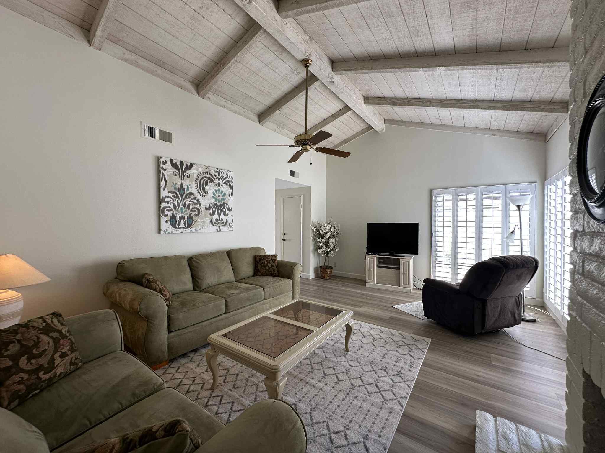 2350 East Miramonte Circle, Unit E Palm Springs, CA 92264 - Photo 18 of 35 a living room with furniture and a wooden floor