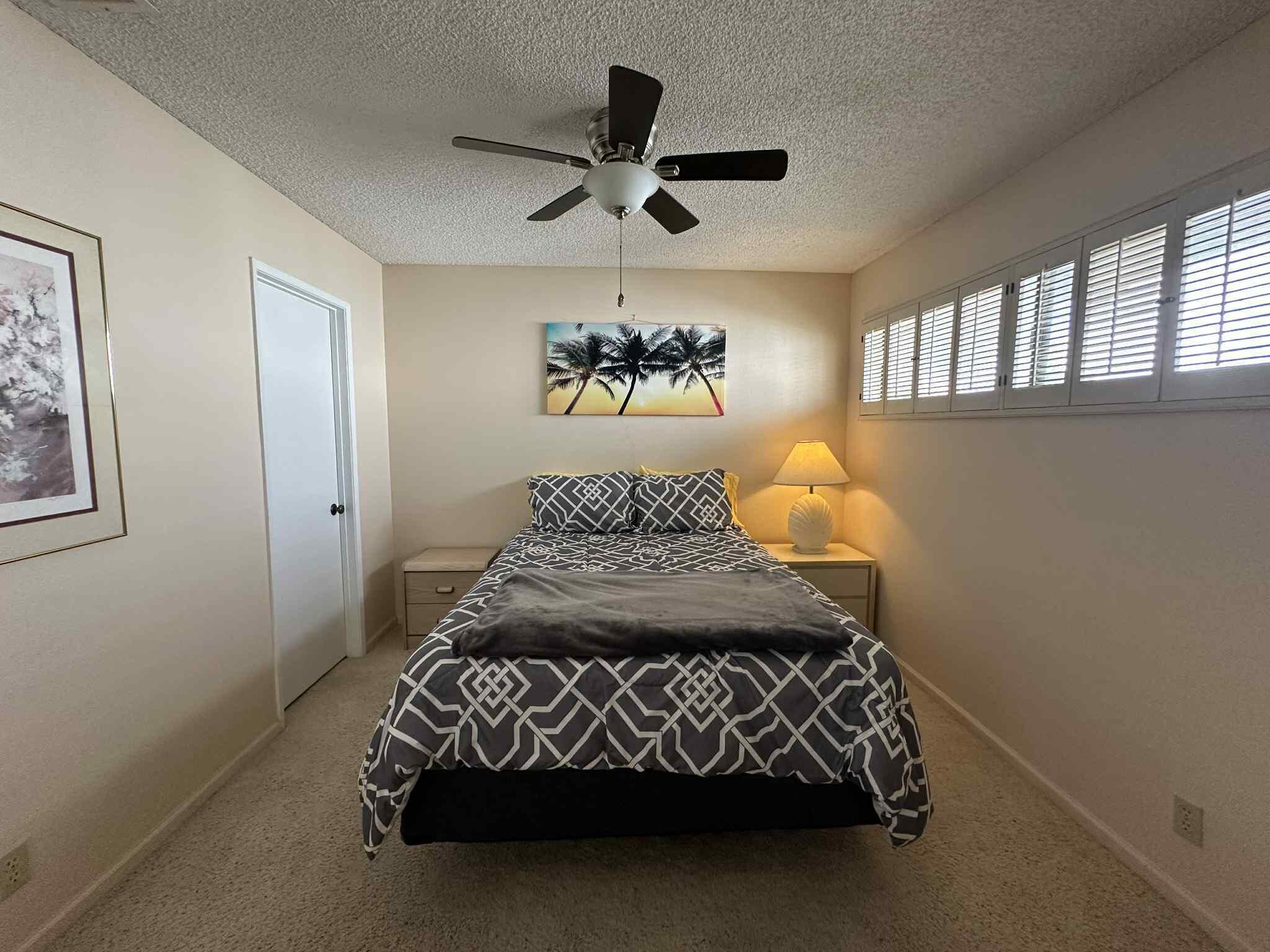 2350 East Miramonte Circle, Unit E Palm Springs, CA 92264 - Photo 28 of 35 a bed sitting in a bedroom next to a window