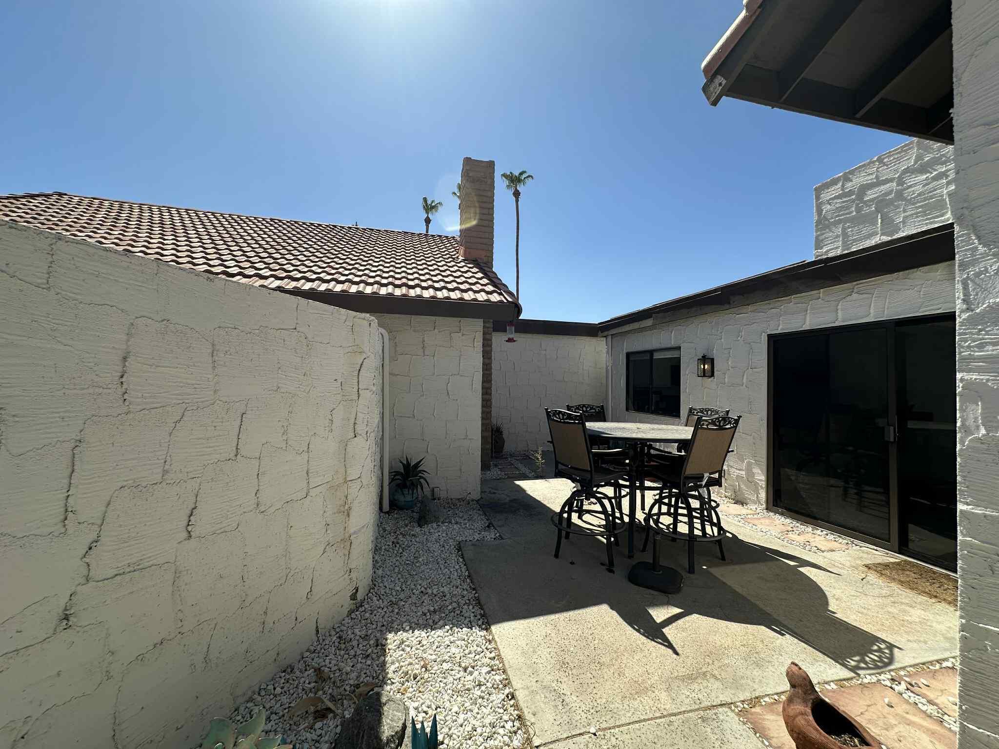 2350 East Miramonte Circle, Unit E Palm Springs, CA 92264 - Photo 32 of 35 a dining room with a table and chairs