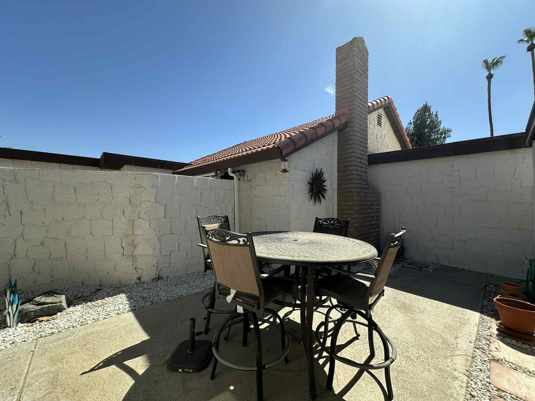 2350 East Miramonte Circle, Unit E Palm Springs, CA 92264 - Photo 34 of 35 a view of a terrace with furniture and stove