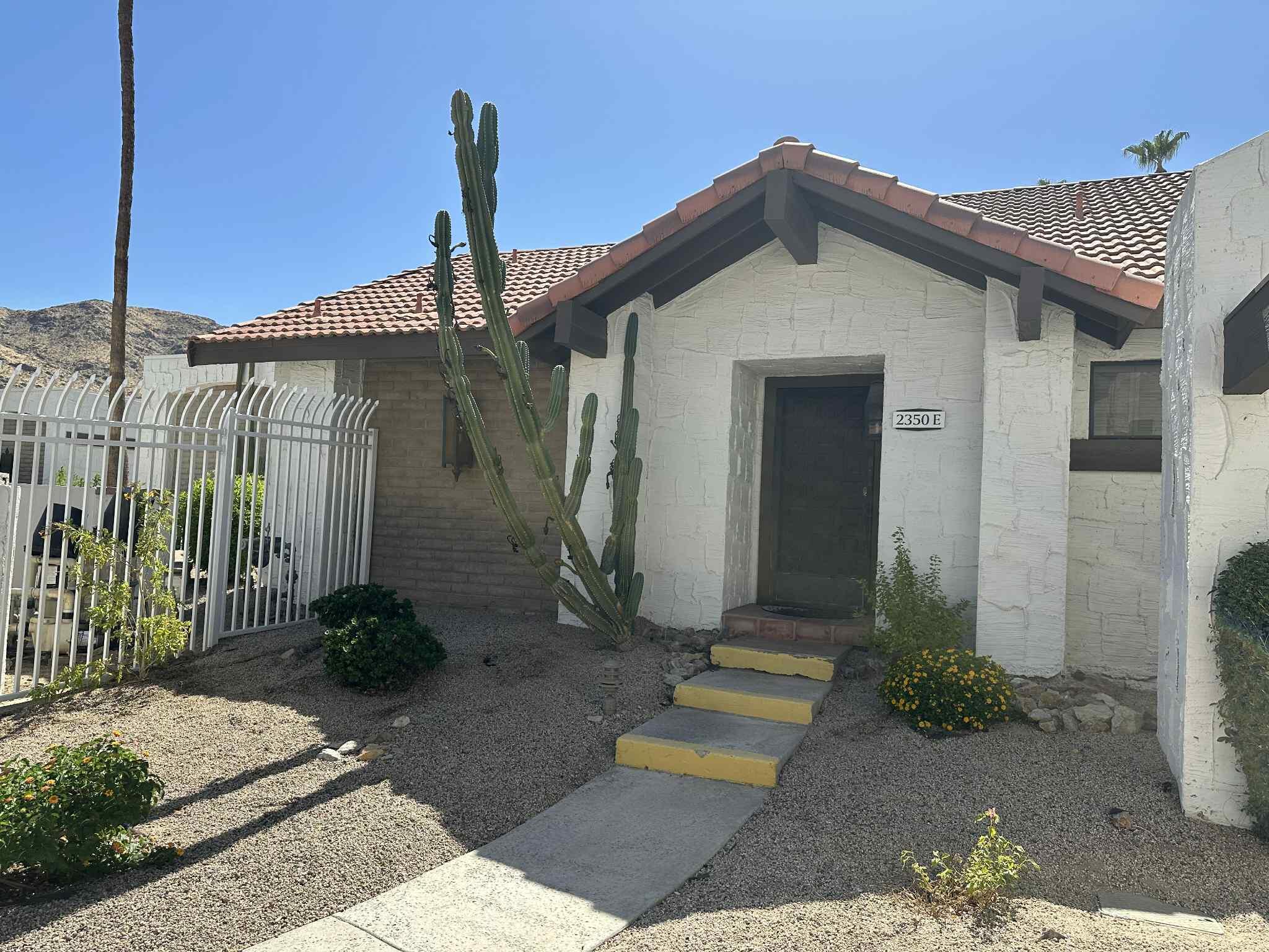 2350 East Miramonte Circle, Unit E Palm Springs, CA 92264 - Photo 8 of 35 a front view of a house with garden