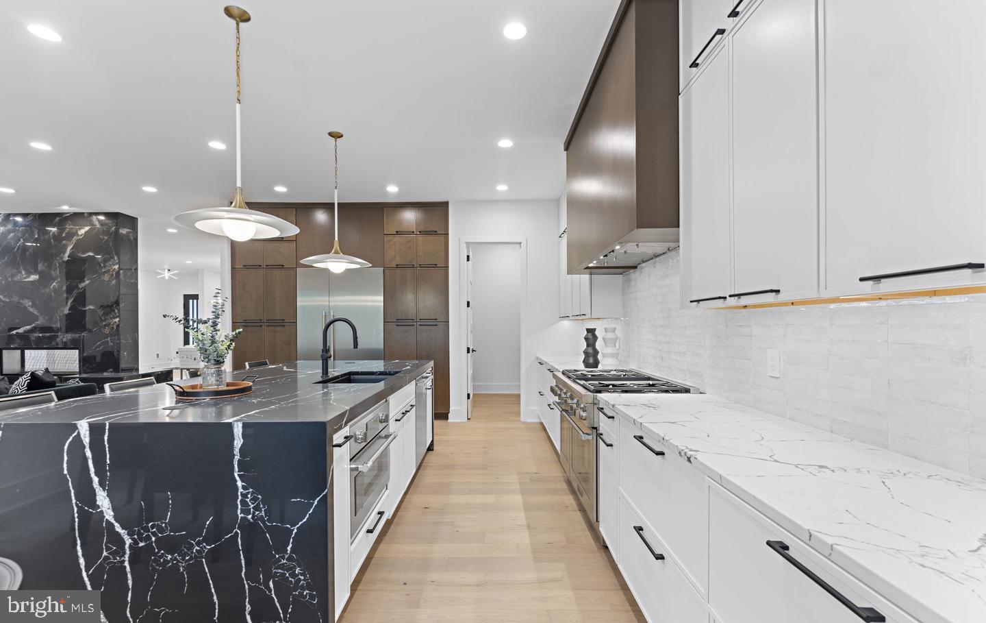 6330 Cross Street McLean, VA 22101 - Photo 7 of 19 a kitchen with stainless steel appliances granite countertop a sink a stove and a wooden floors