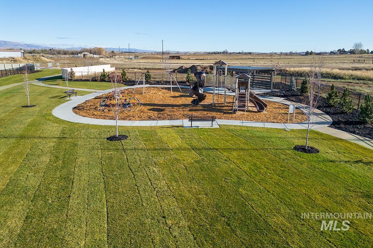1700 East Hadler Street Meridian, ID 83642 - Photo 22 of 25 Community playground featuring a multi-level play structure with slides, swings, and a wood chip surface