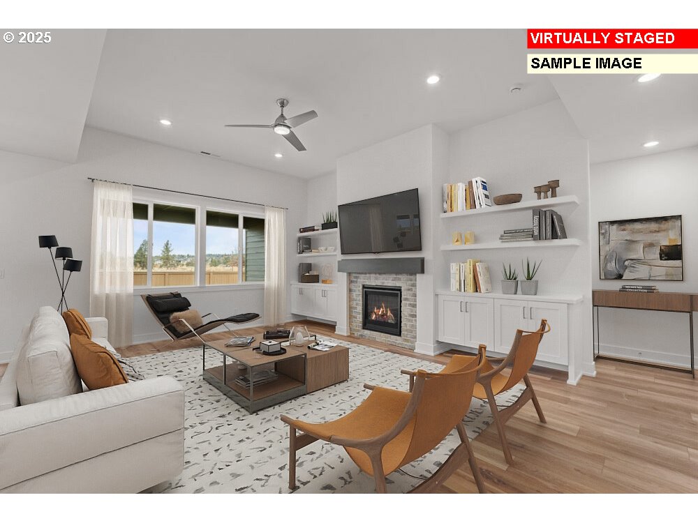 1146 Southeast 18th Avenue Canby, OR 97013 - Photo 4 of 17 a living room with furniture a fireplace and a flat screen tv