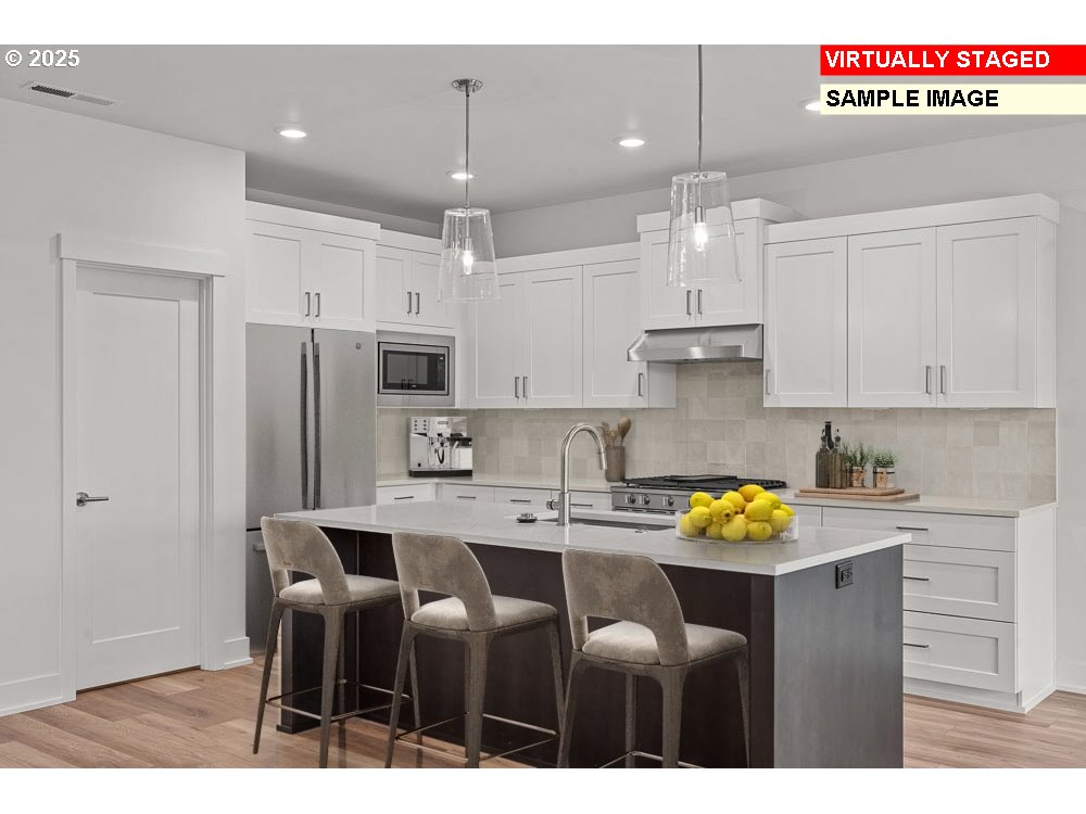 1146 Southeast 18th Avenue Canby, OR 97013 - Photo 5 of 17 a kitchen with stainless steel appliances granite countertop a sink cabinets and refrigerator