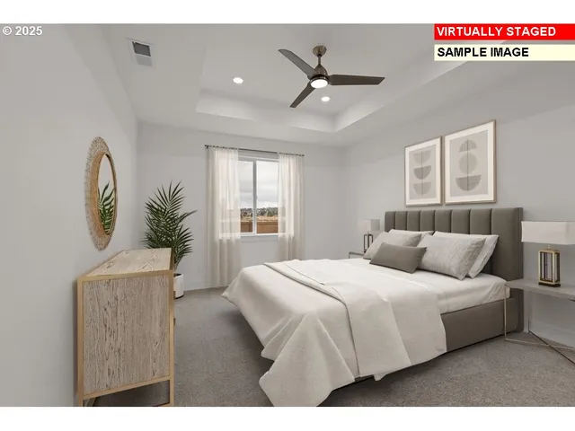 a bedroom with a large bed and a chandelier