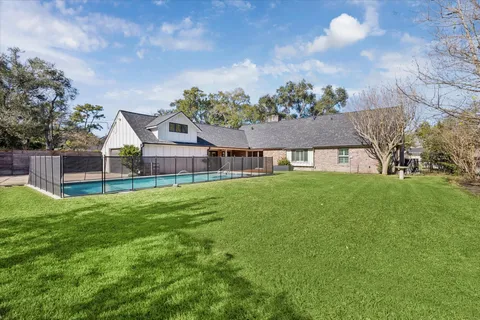 a front view of a house with a garden and deck