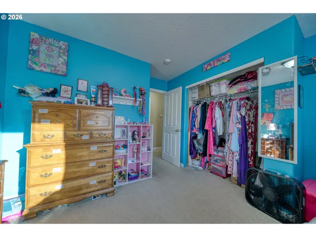 a view of walk in closet with clothes