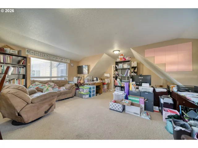 a living room with lots of furniture and clutter
