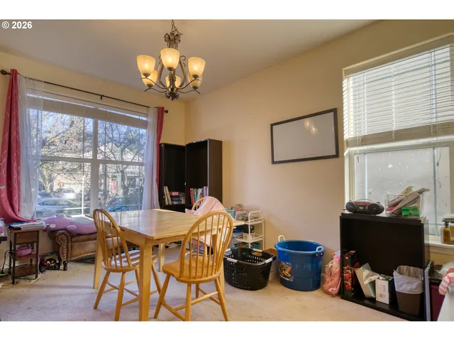 a view of a dining room with furniture a chandelier and wooden floor