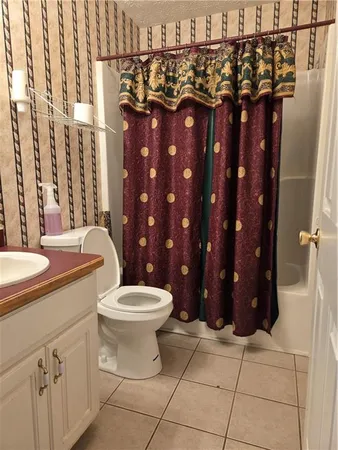 a bathroom with a toilet a sink and shower