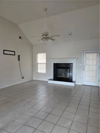an empty room with fireplace and windows