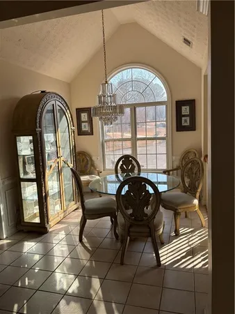 a view of a dining room with furniture and chandelier