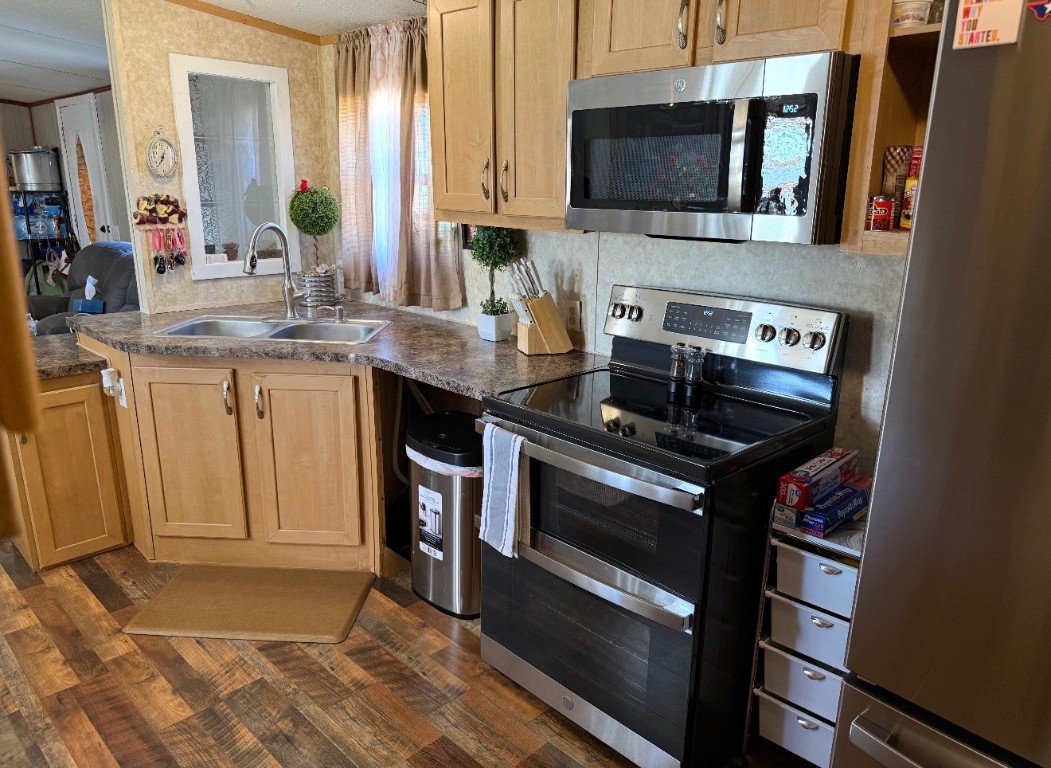 18504 Noyce Road Crosby, TX 77532 - Photo 13 of 24 a kitchen with stainless steel appliances a stove microwave and sink