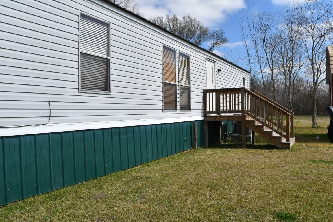18504 Noyce Road Crosby, TX 77532 - Photo 21 of 24 a view of a house with a wooden deck