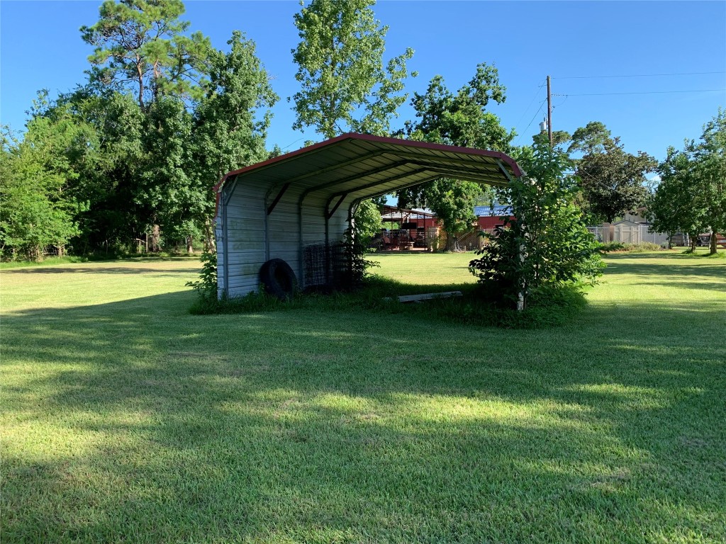 18504 Noyce Road Crosby, TX 77532 - Photo 6 of 24 a view of a garden with a table and chairs under an umbrella