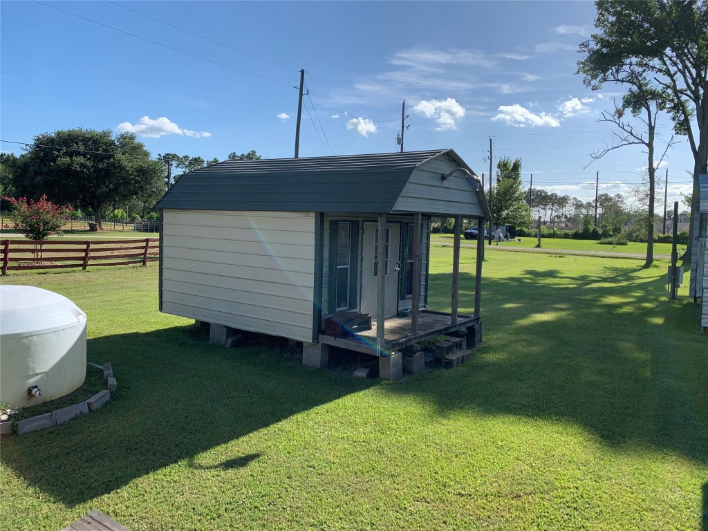 18504 Noyce Road Crosby, TX 77532 - Photo 9 of 24 a view of a patio with a table chairs and a fire pit