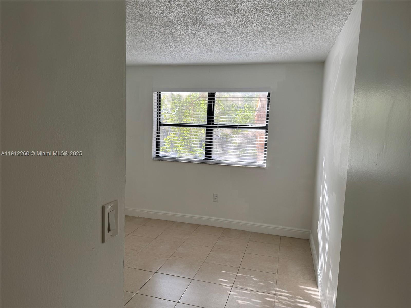 15630 Southwest 80th Street, Unit I209 Miami, FL 33193 - Photo 12 of 19 a view of an empty room with a window
