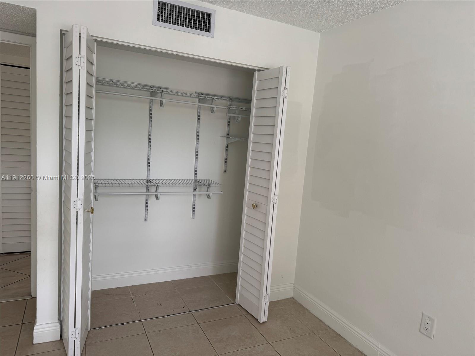 15630 Southwest 80th Street, Unit I209 Miami, FL 33193 - Photo 14 of 19 a view of an empty walk in closet
