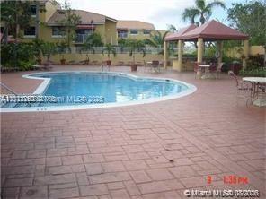 15630 Southwest 80th Street, Unit I209 Miami, FL 33193 - Photo 16 of 19 a view of a swimming pool with a patio