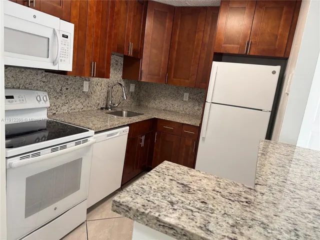 a kitchen with a refrigerator and a sink