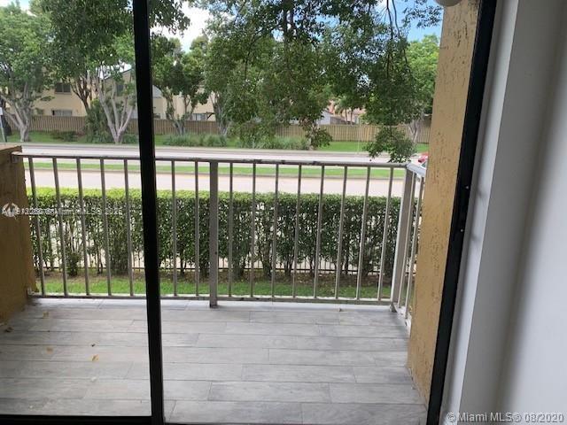 15630 Southwest 80th Street, Unit I209 Miami, FL 33193 - Photo 8 of 19 a view of backyard from balcony