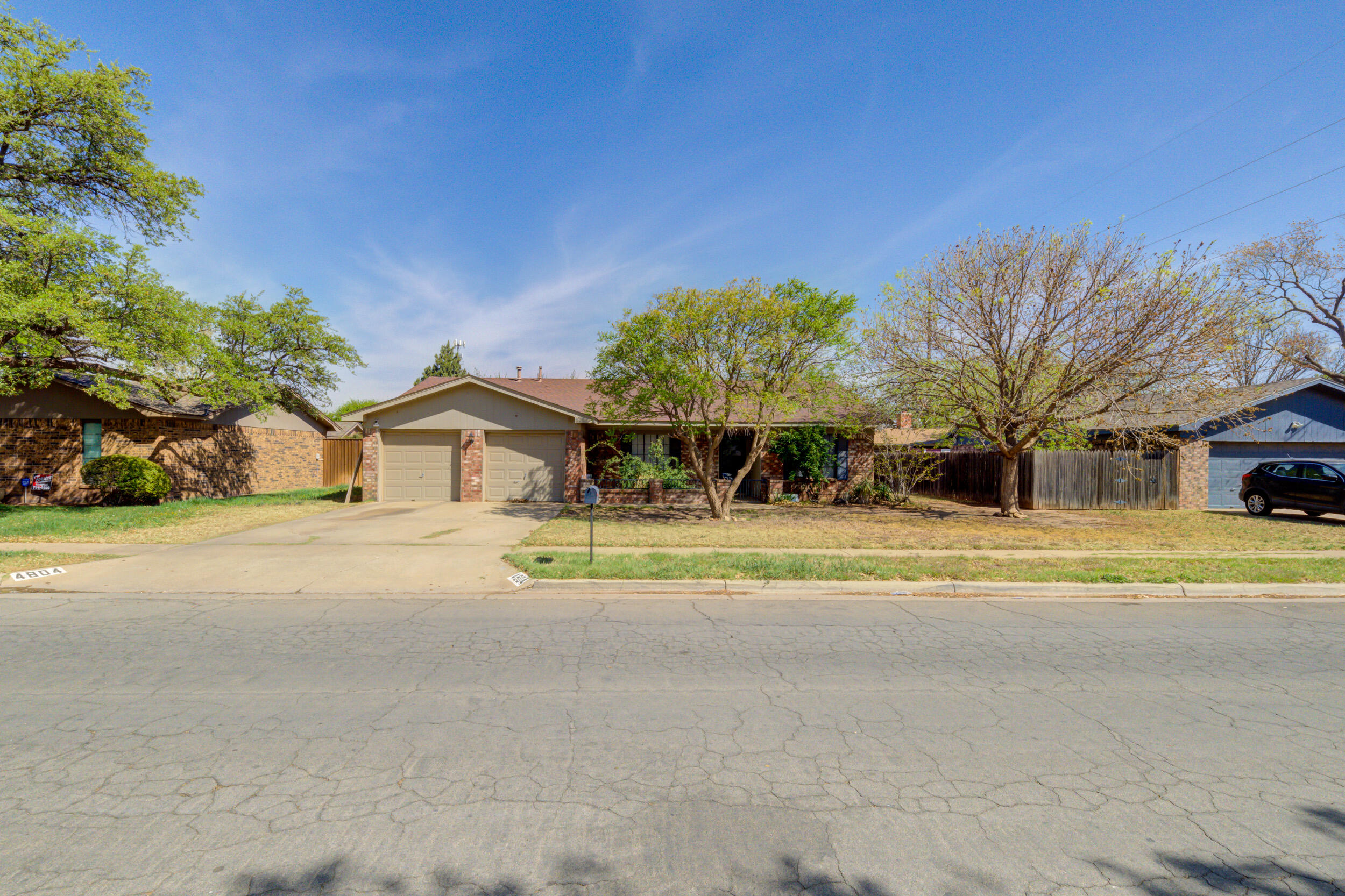 4804 71st Street Lubbock, TX 79424 - Photo 1 of 14 a view of a house with a yard and potted plants