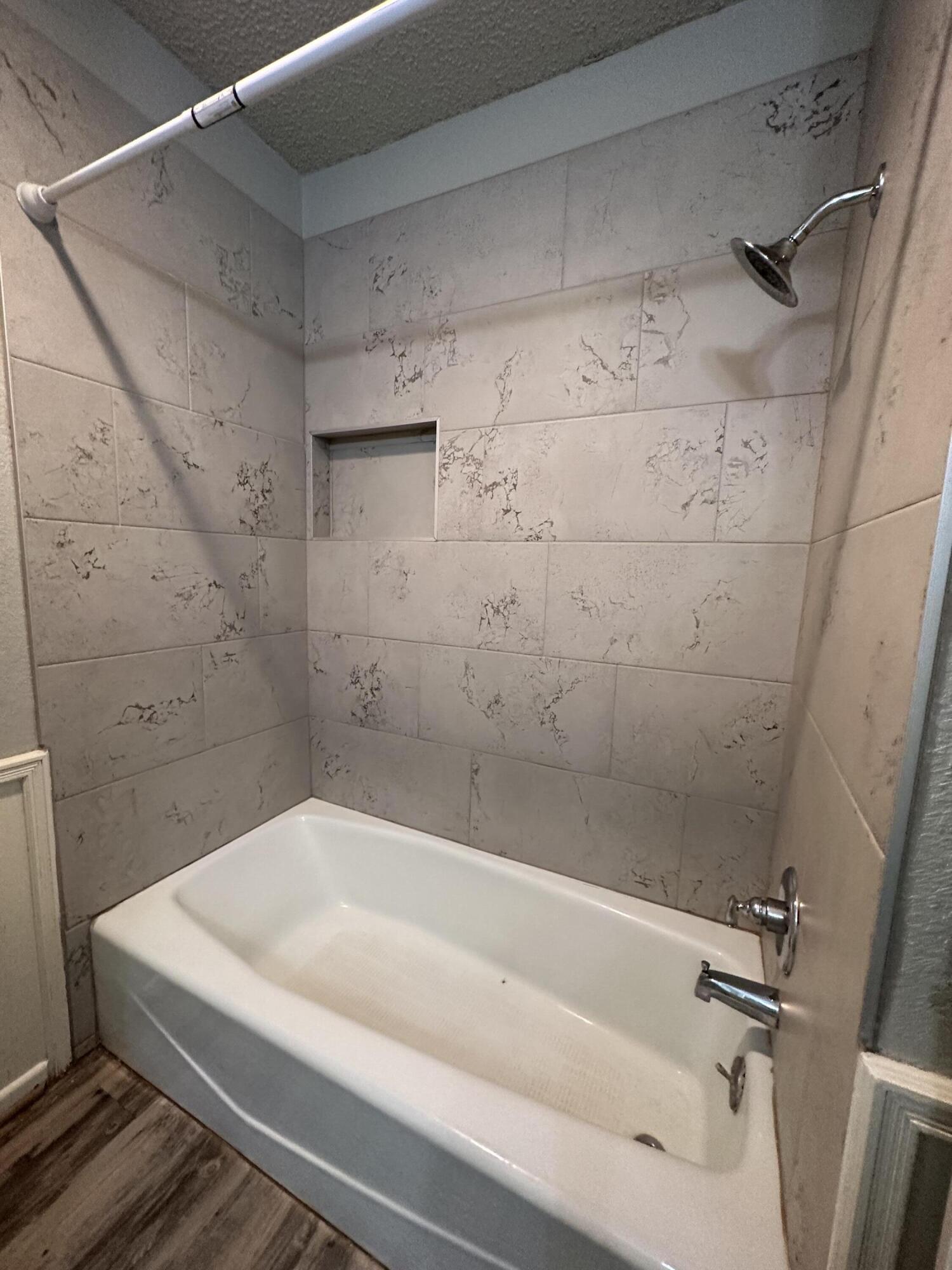 4804 71st Street Lubbock, TX 79424 - Photo 13 of 14 a bathroom with a white bathtub