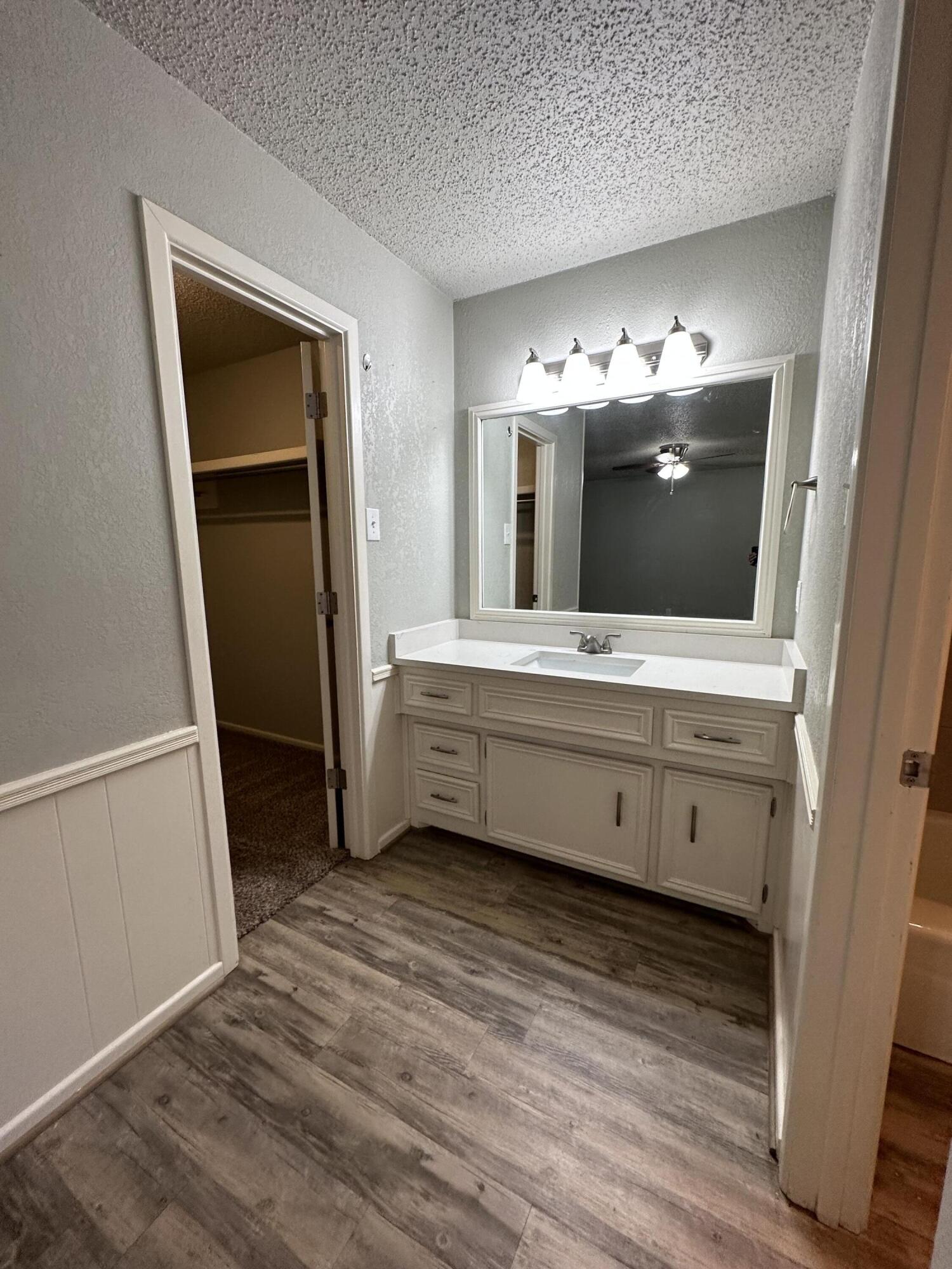 4804 71st Street Lubbock, TX 79424 - Photo 8 of 14 a bathroom with a double vanity sink and mirror