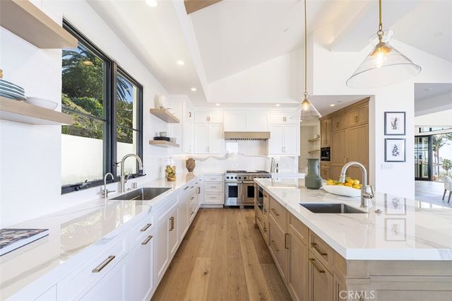 a kitchen with sink a stove and a wooden floors