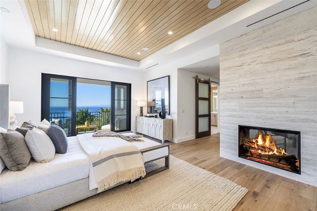 a spacious bedroom with a bed and a fireplace