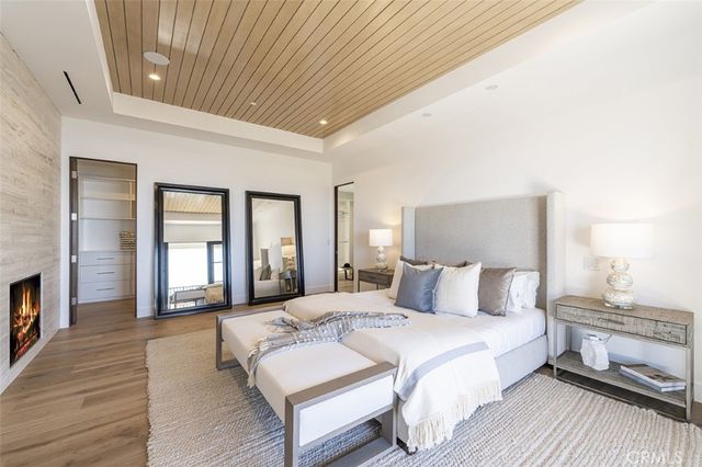 a bedroom with a bed wooden floor and window