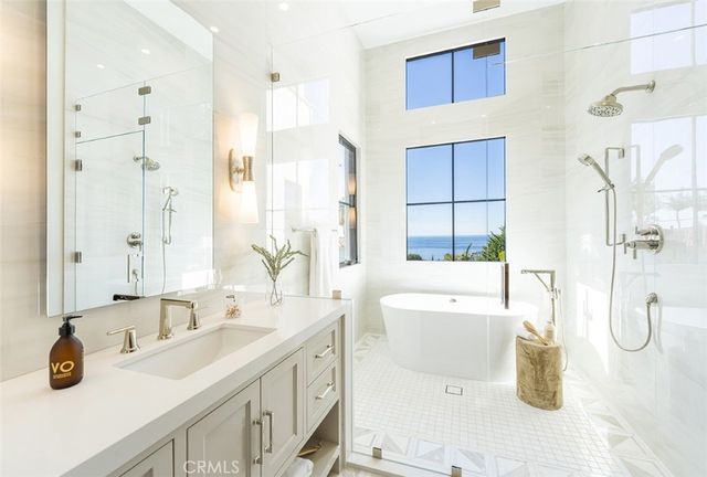 a bathroom with a tub sink and mirror
