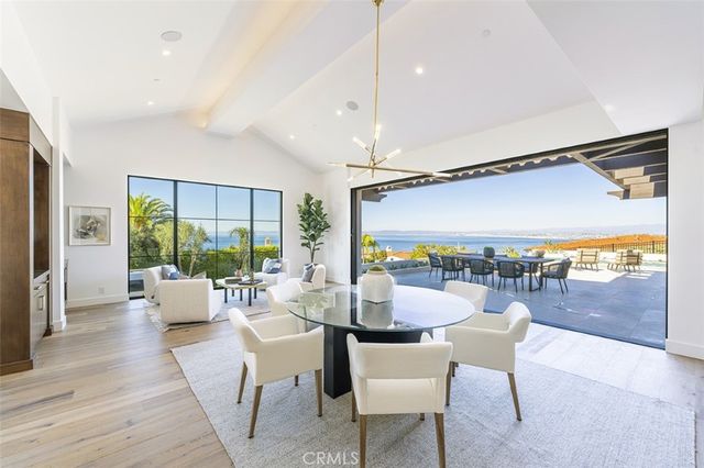a dining room with furniture a chandelier and wooden floor